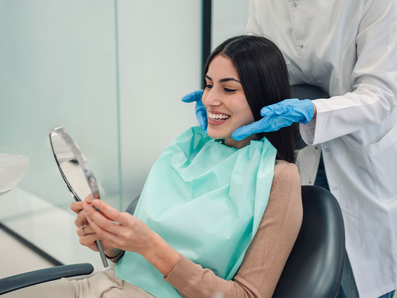 a child smiling and giving the thumbs up